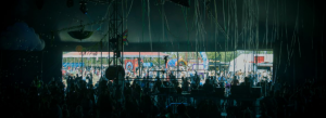 A crowd at an outdoor evening event with a lit stage, the kind of gathering that needs security services for events in South Florida